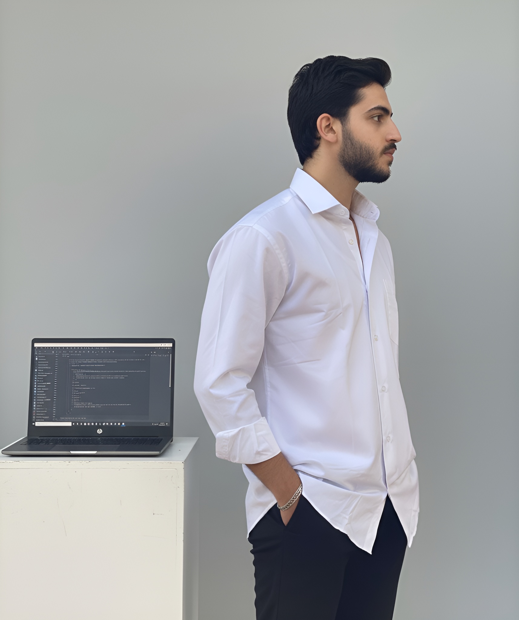 portrait image of Huy standing in front of a tree and foliage